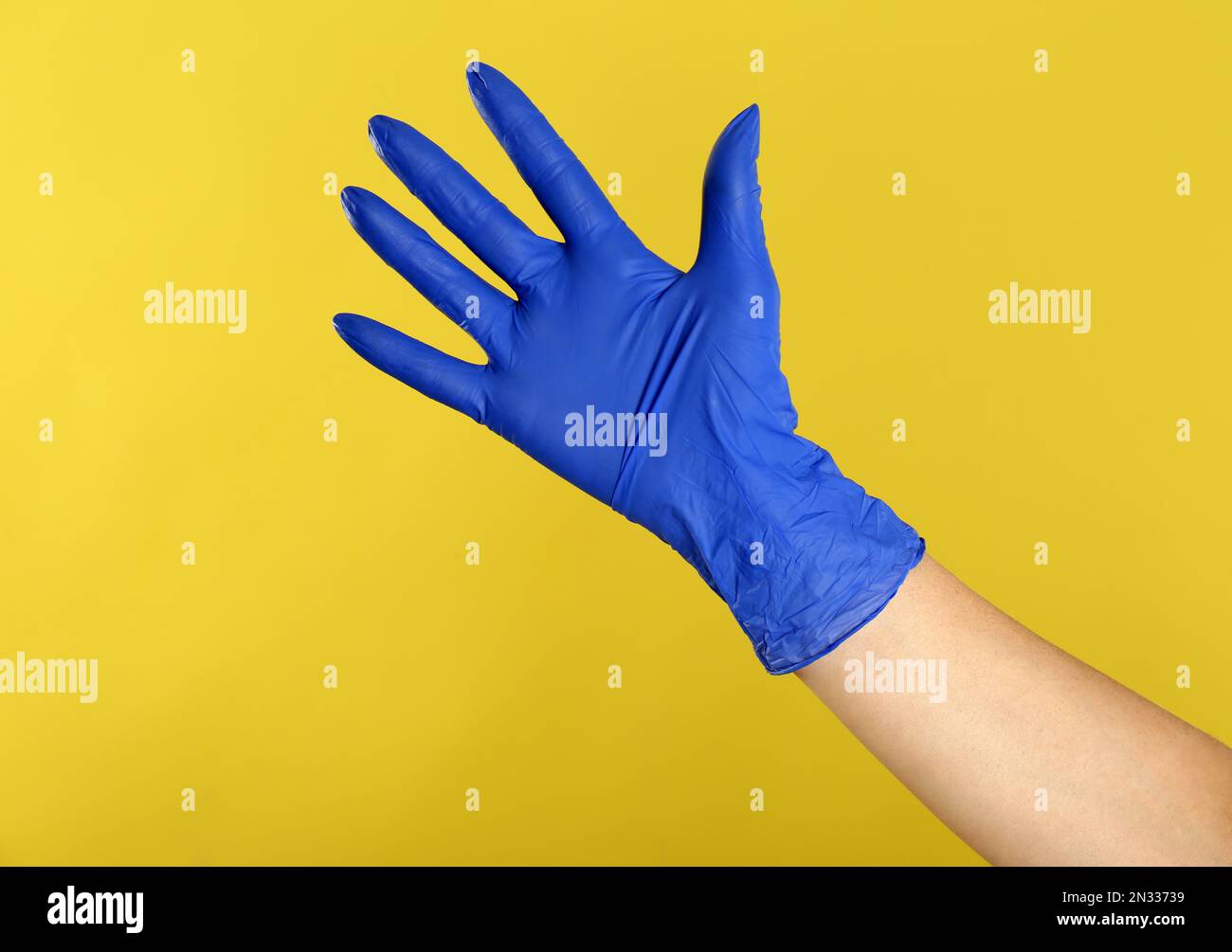 Hand in blue nitrile gloves hi-res stock photography and images - Alamy