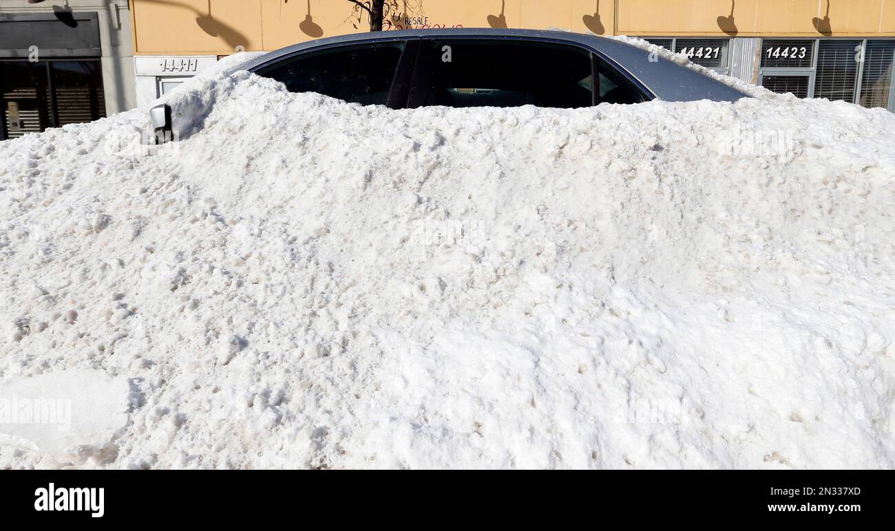 A car is covered in plowed snow in Detroit, Monday, Feb. 2, 2015. A