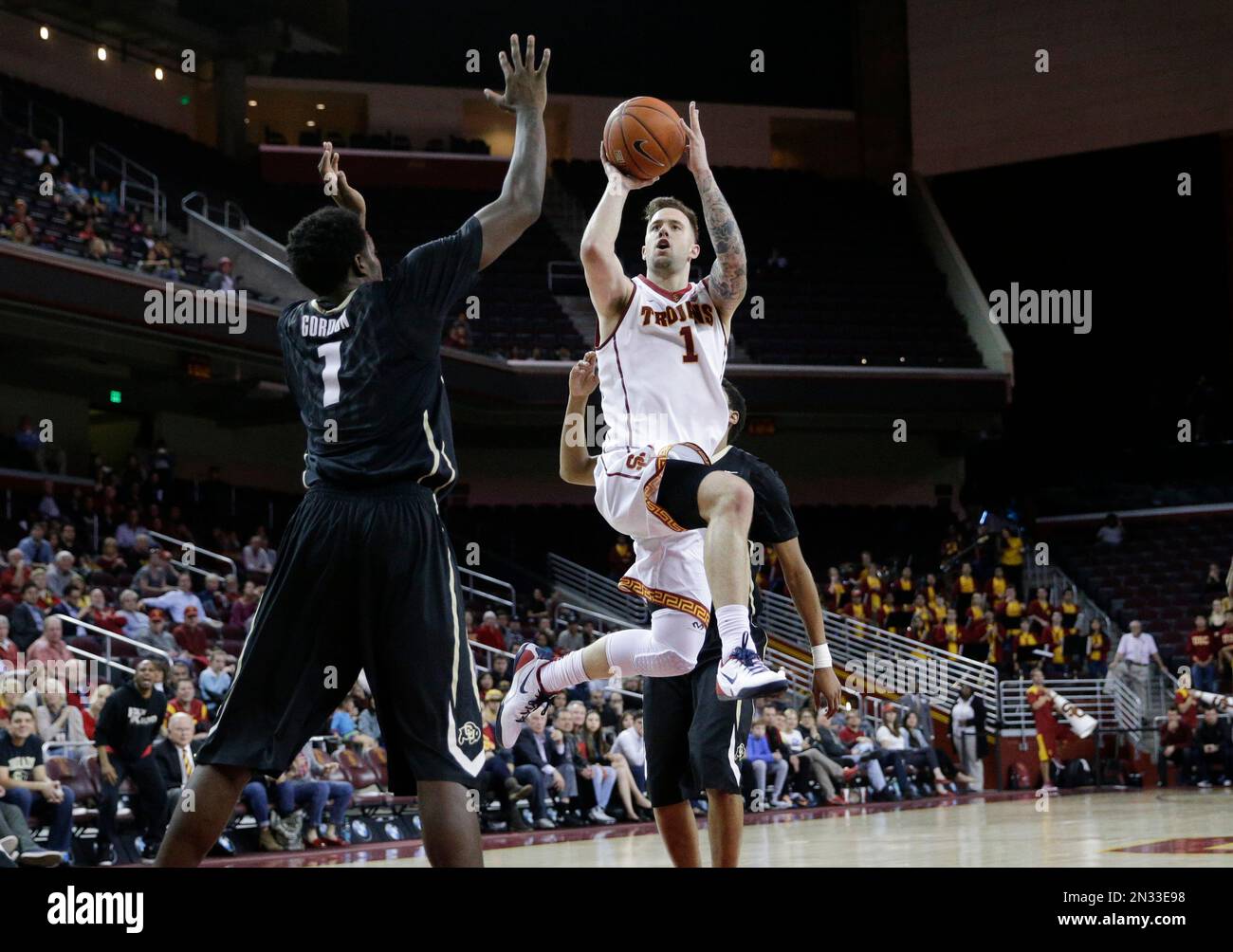 Southern California's Katin Reinhardt, center, shoots during overtime