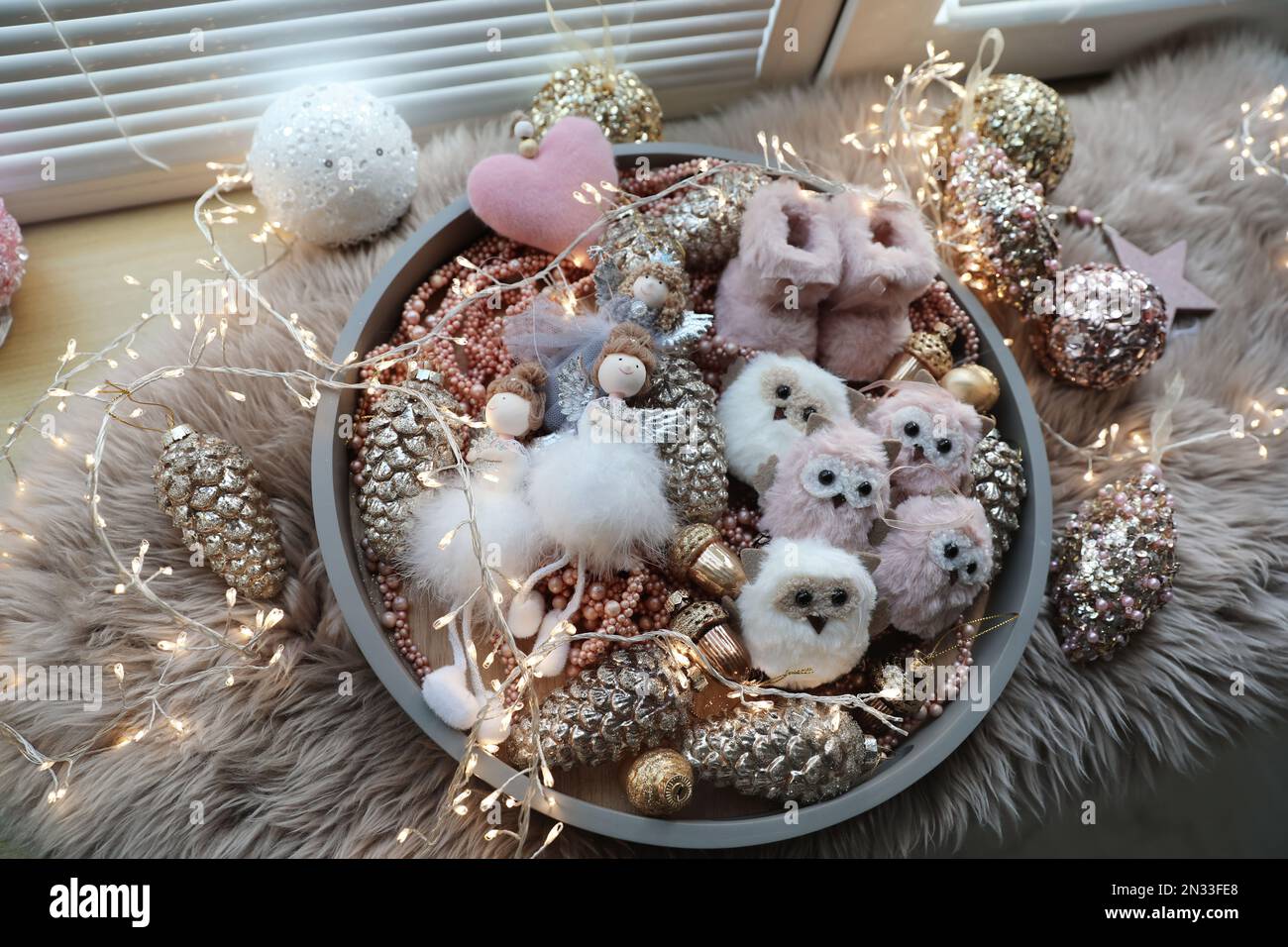 Beautiful Christmas tree baubles, toys and fairy lights on window sill, above view Stock Photo
