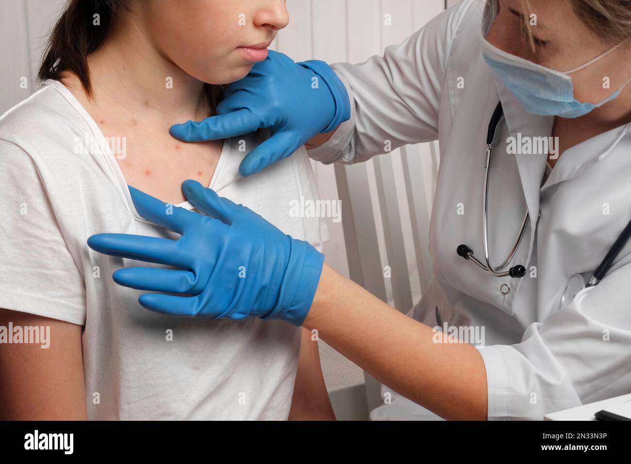 Doctor Checking Skin of Sick Girl. Kid with Red Rash being Examined at