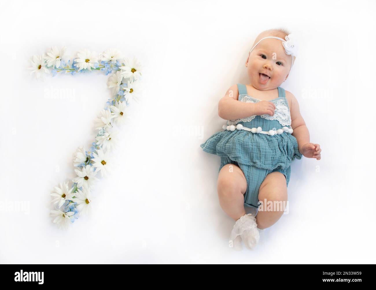 little-caucasian-newborn-baby-girl-in-a-blue-dress-7-month-old-baby