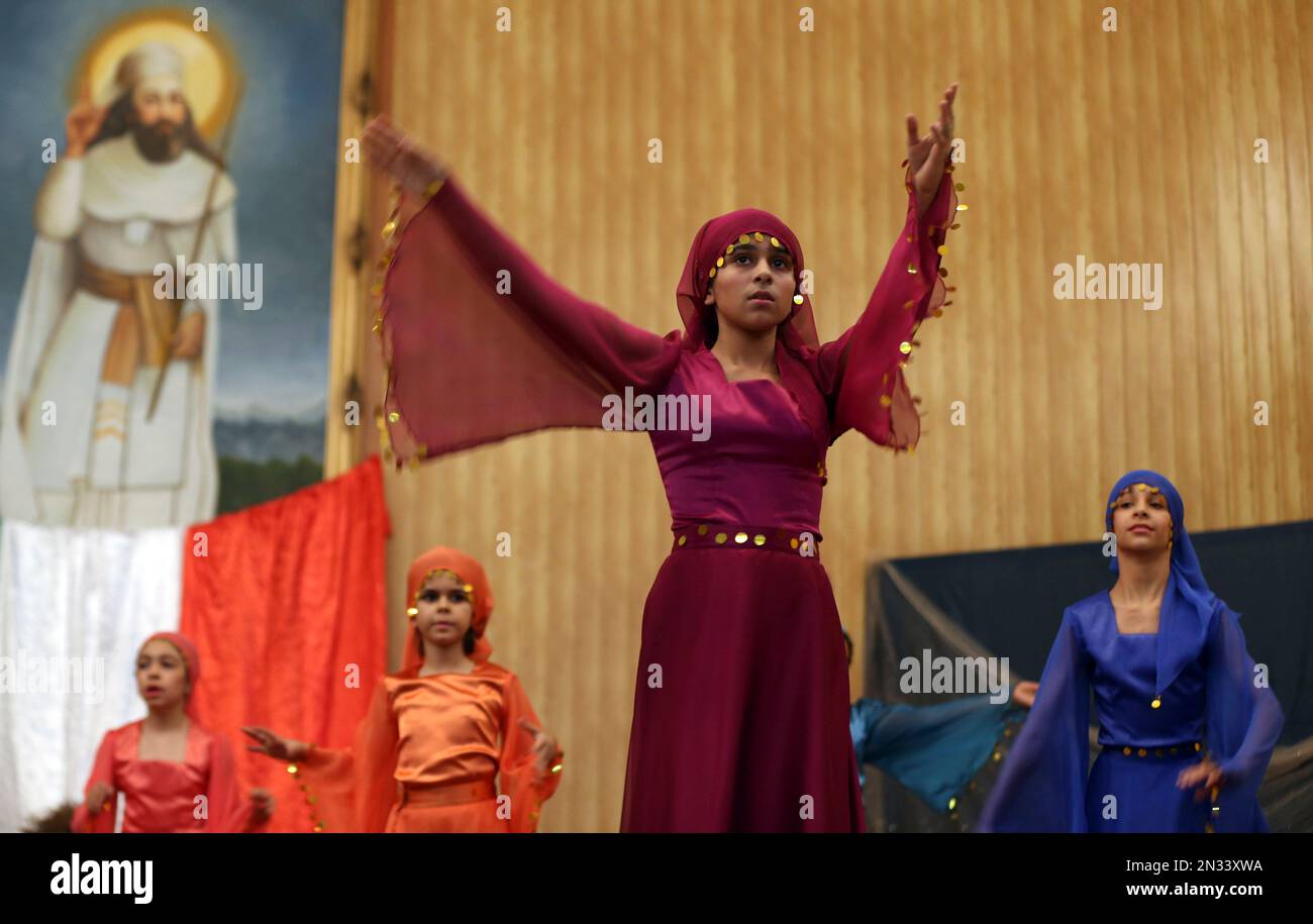 Iranian Zoroastrian girls dance in front of a portrait of Prophet