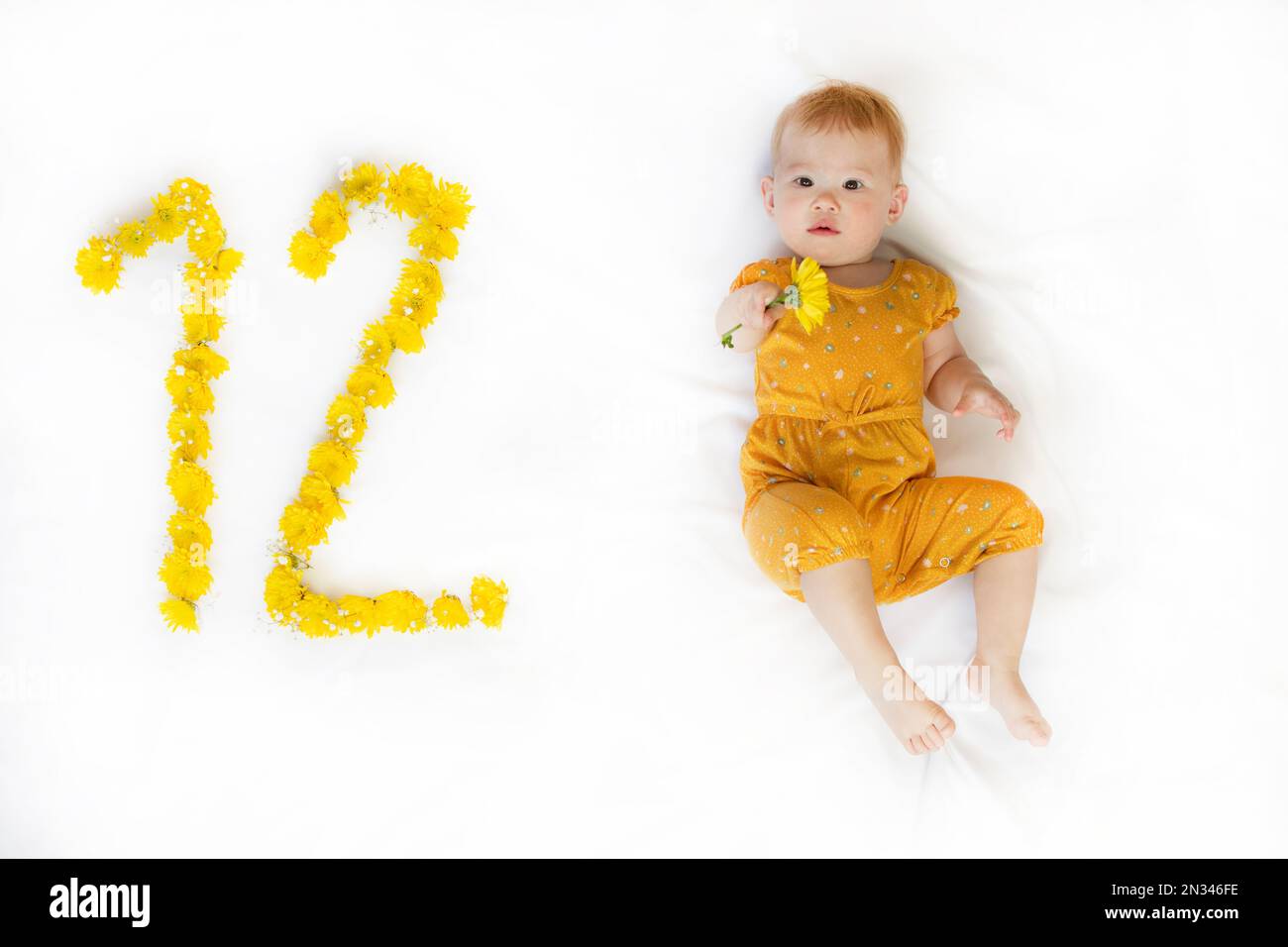 12-month-old baby girl. Baby milestone two months. Twelve month old baby Stock Photo