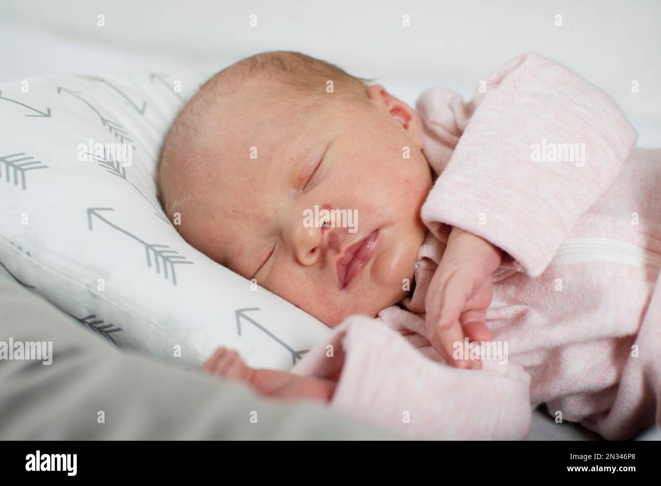 Caucasian Newborn baby sleeping in a baby lounger. Baby nest Stock Photo Alamy