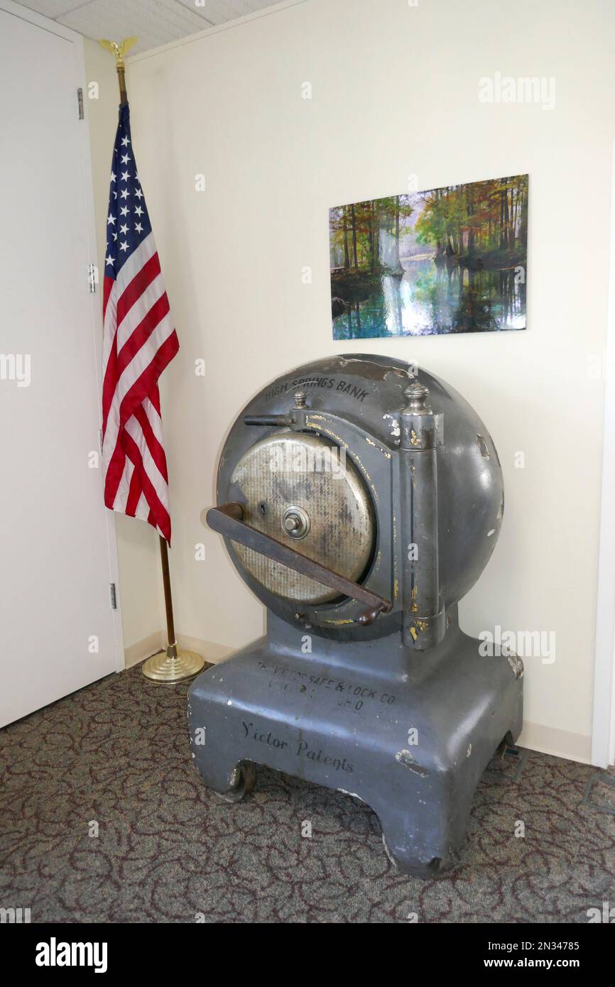 Old Bank vault dating from the 1880's sits in a corner of the lobby of a modern day bank in a small North Florida town. AKA CANNONBALL SAFE Stock Photo