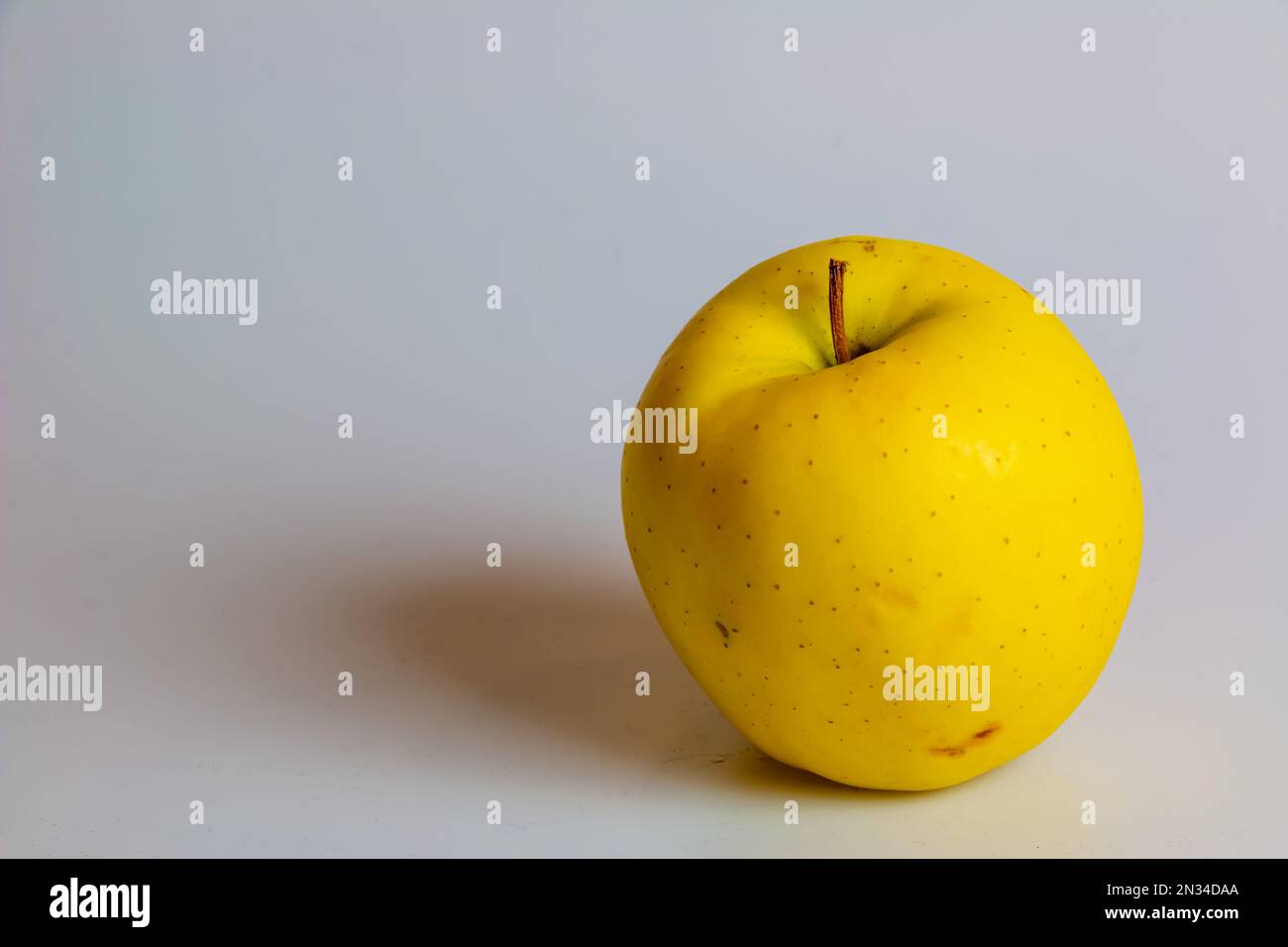 Yellow apples of the Golden Delicious variety on a white background