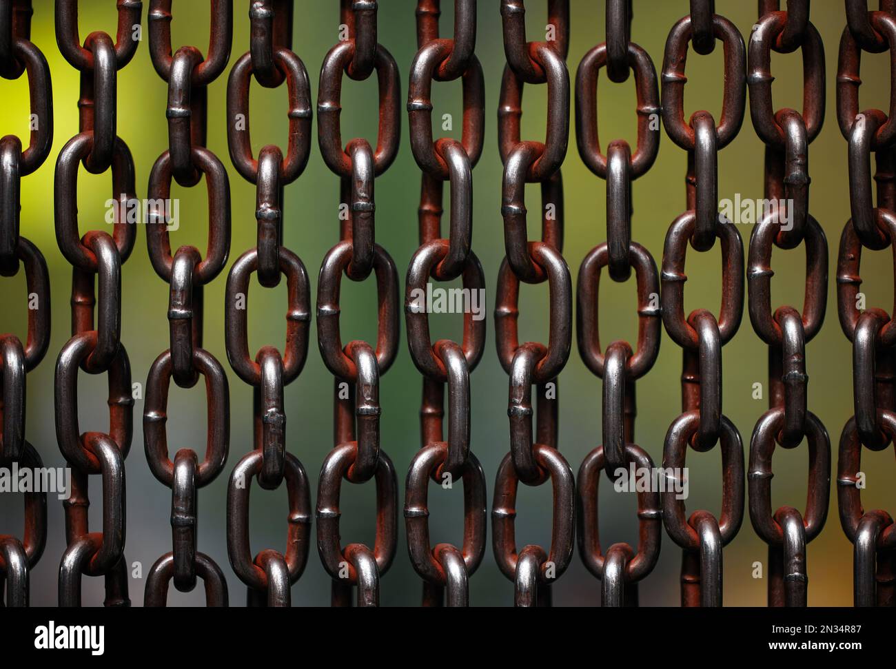 Background of metal chains, old used chain. Metal curtain on the entrance of bird park. The door made of chain link to prevent the bird fly away from Stock Photo