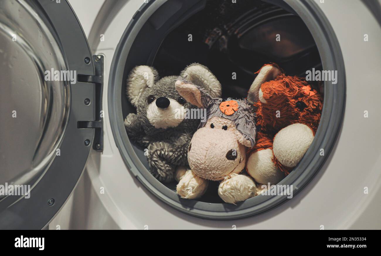 Baby toys in the washing machine. Plush, fluffy toys after washing