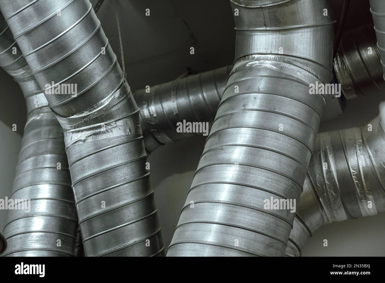 Ventilation pipes are intertwined under the ceiling. Tin stoves are installed in the large