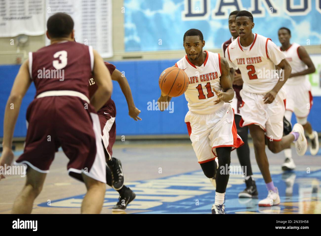 Life Center's Traci Carter 11 in action against MacDuffie during their