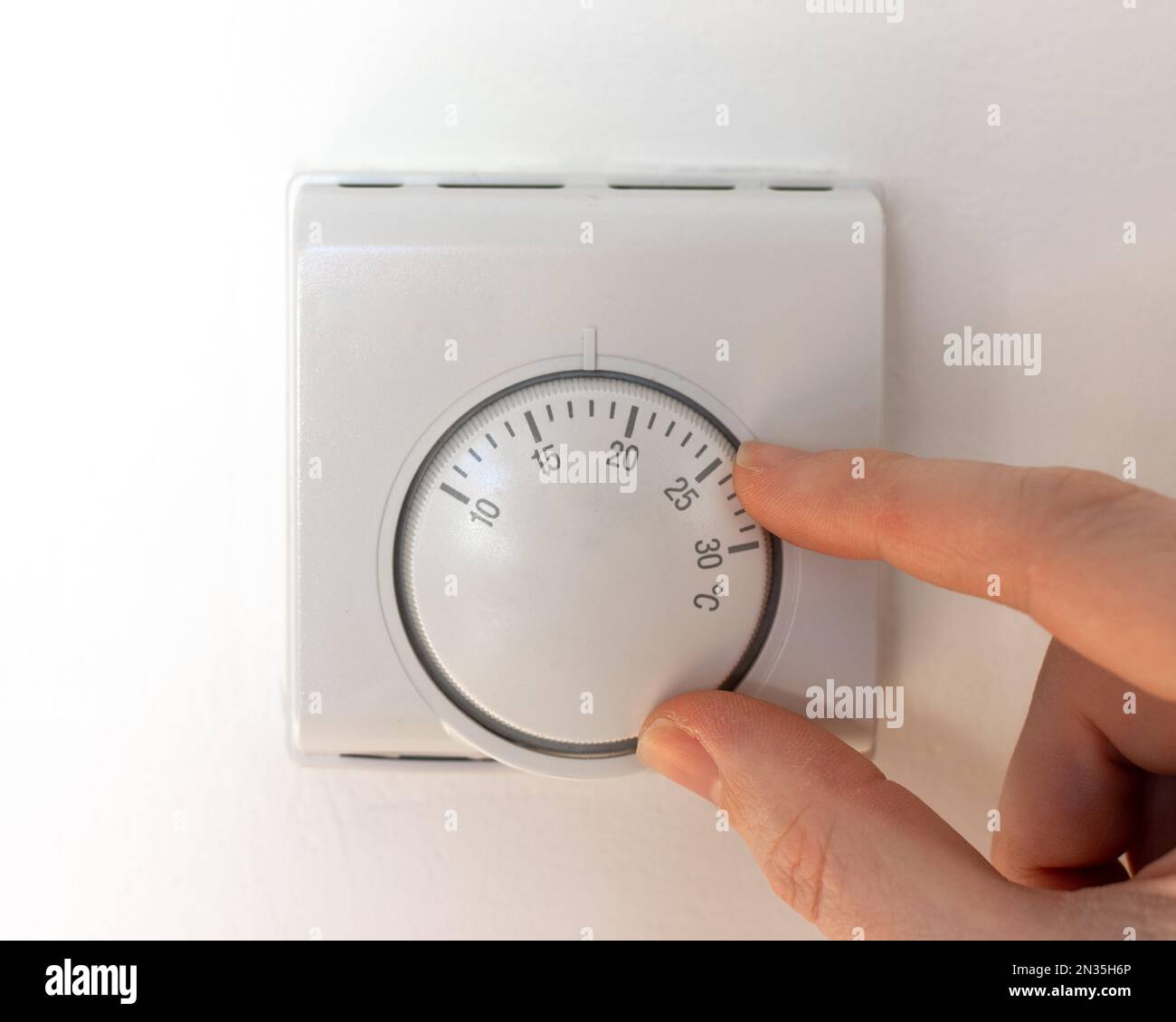 A man turning the thermostat dial, heating and cost of energy concept Stock Photo Alamy