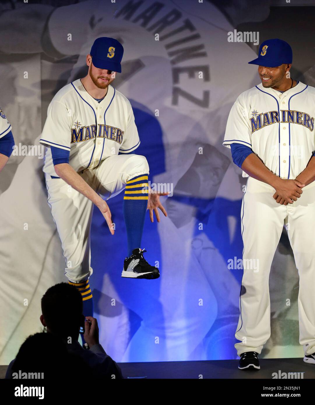 Seattle Mariners' Charlie Furbush, left, points out new socks as teammate  Nelson Cruz looks on as the team's new alternate Sunday uniforms are  modeled during an unveiling, Friday, Jan. 23, 2015, in