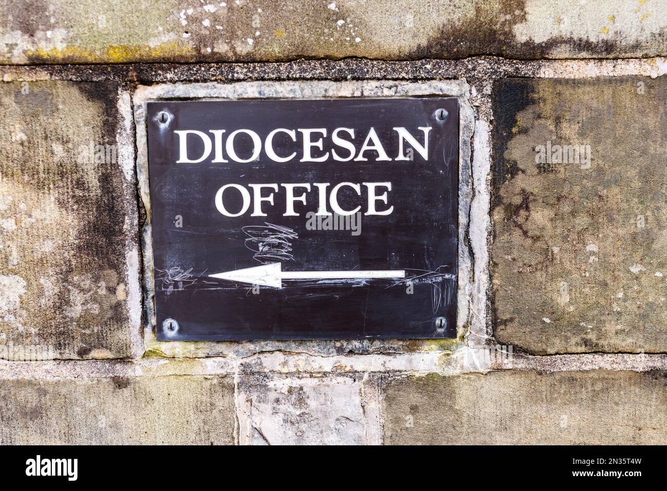 Sign pointing to the Diocesan Office of a church. Stock Photo