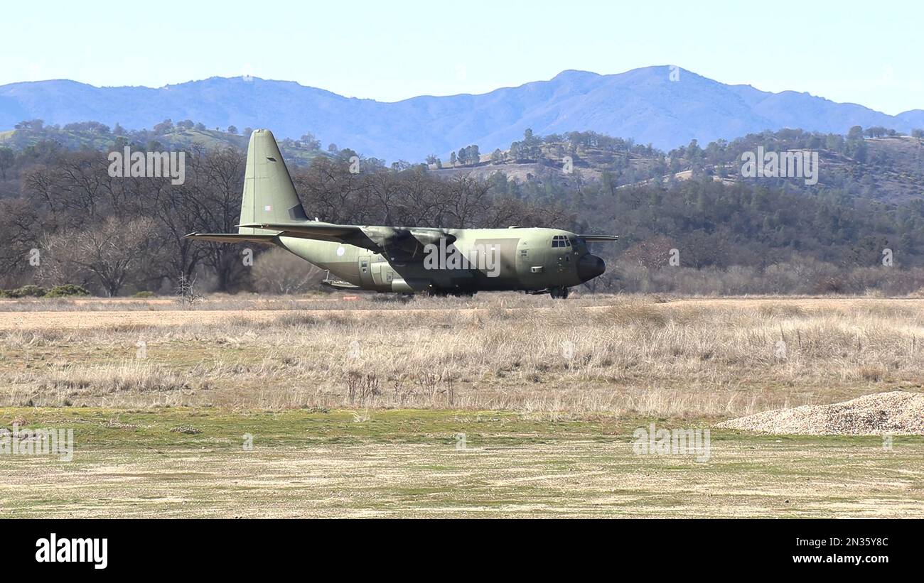 U.S. Air Force Lockheed Hercules C-130 cargo aircraft practices landing/takeoffs at Fort Hunter Liggett, CA dirt airstrip. Stock Photo