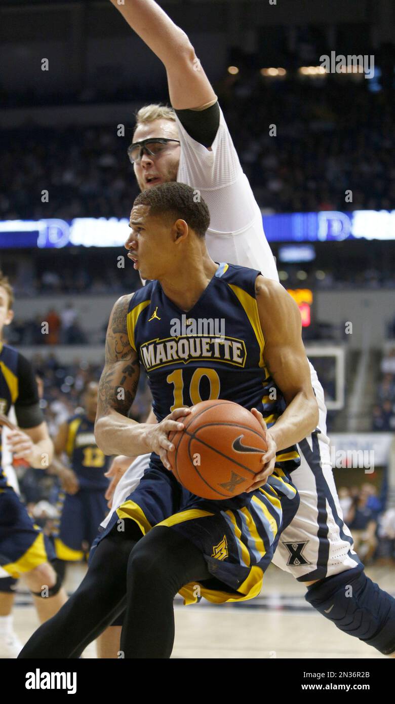 Marquette Forward Juan Anderson (10) Is Pressured By Xavier Center Matt ...