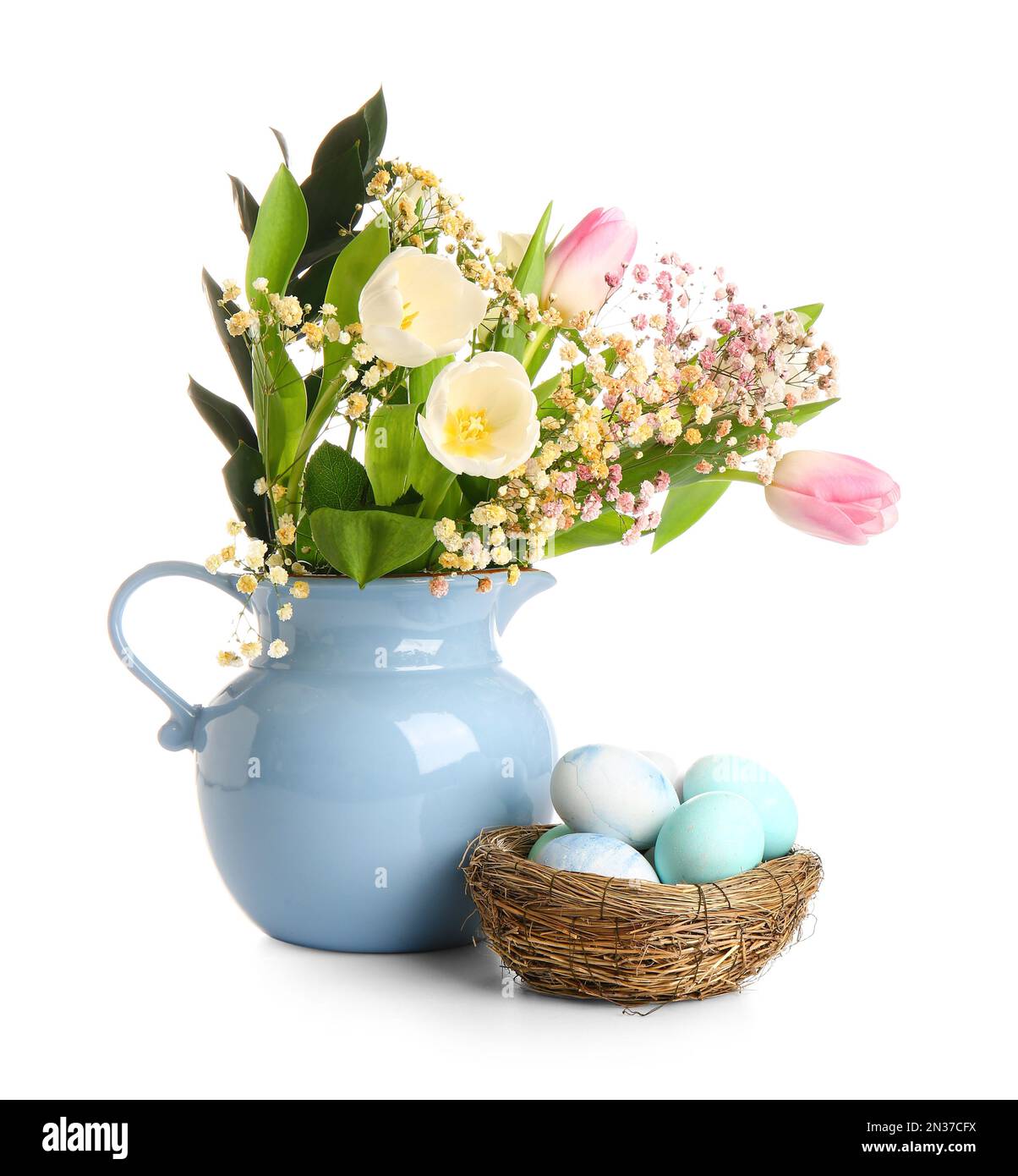 Nest of Easter eggs and jug with beautiful flowers on white background ...
