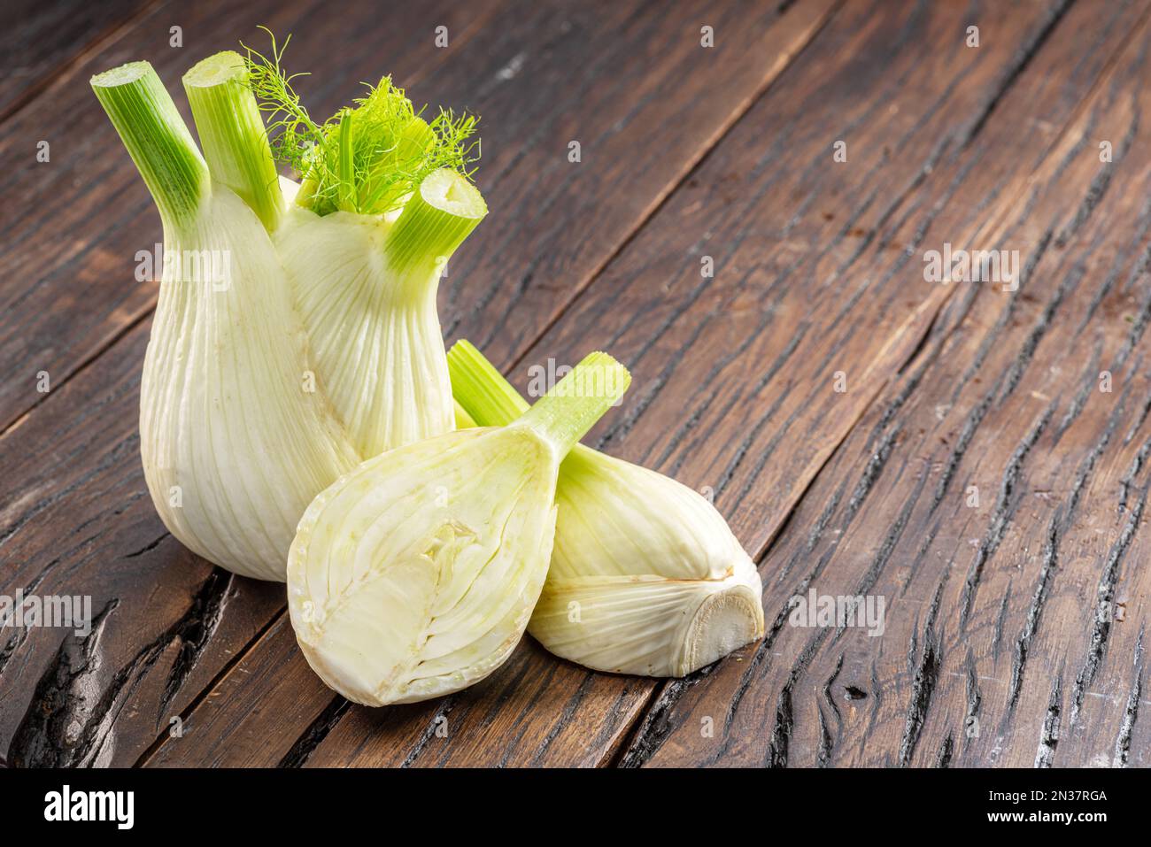 Florence fennel bulbs on aged wood background. Stock Photo