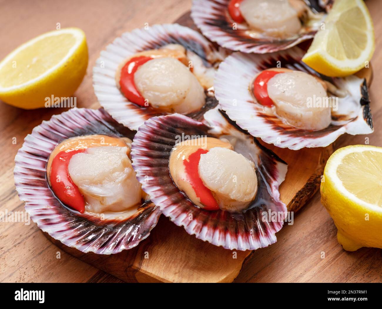 Group of fresh opened scallop with scallop roe or coral close up Stock
