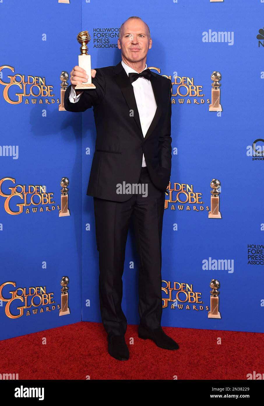 Michael Keaton poses in the press room with the award for best actor in
