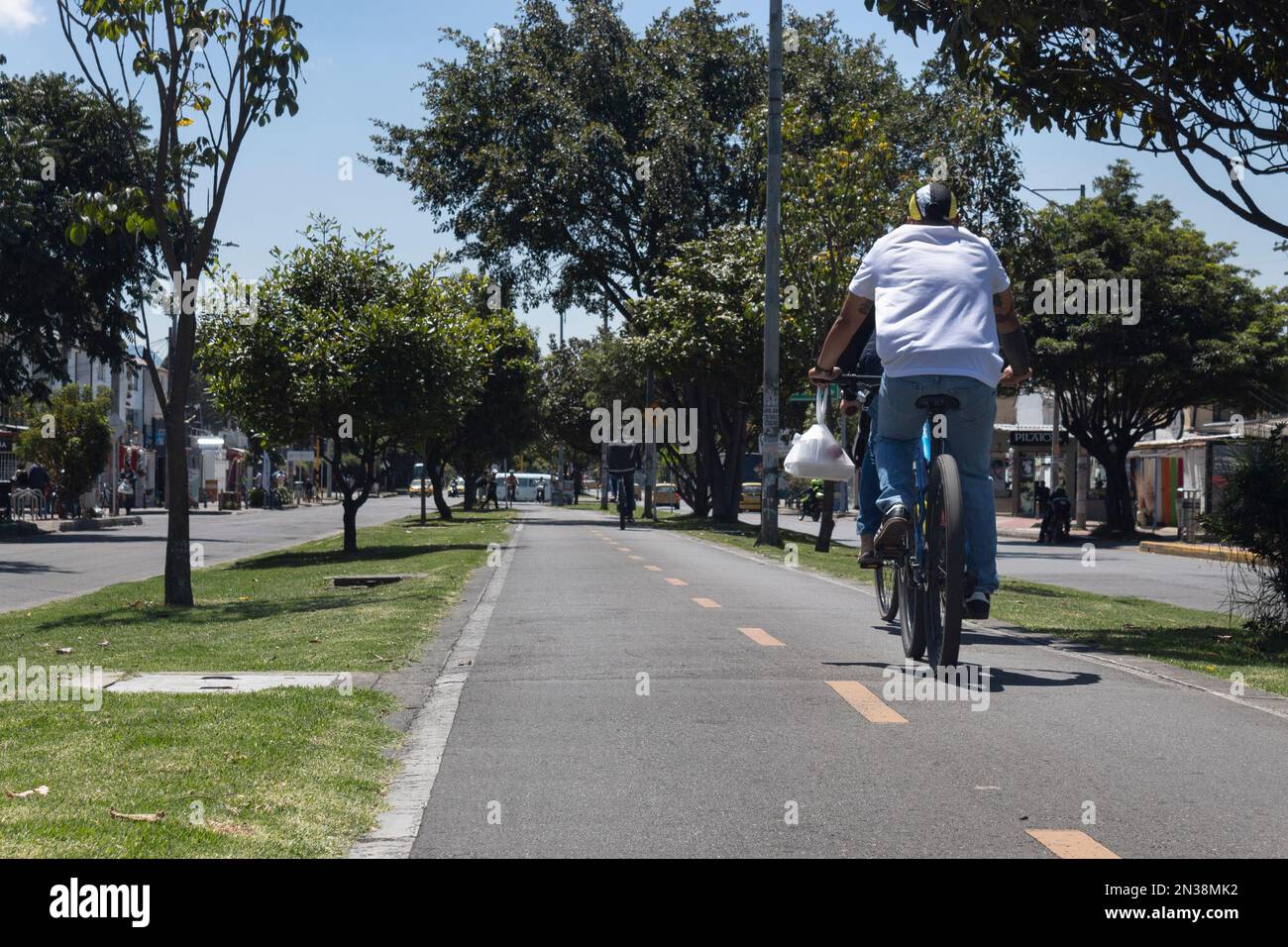 BOGOTA, COLOMBIA A delivery courier man on bycicle transiting over a