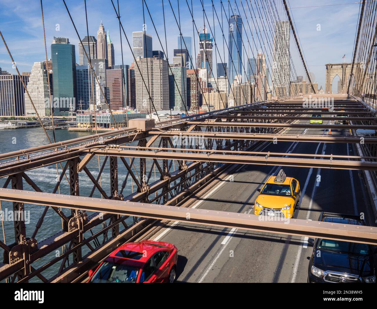 Manhattan Skyline and Traffic crossing the Brooklyn Bridge, Brooklyn, New York, USA Stock Photo