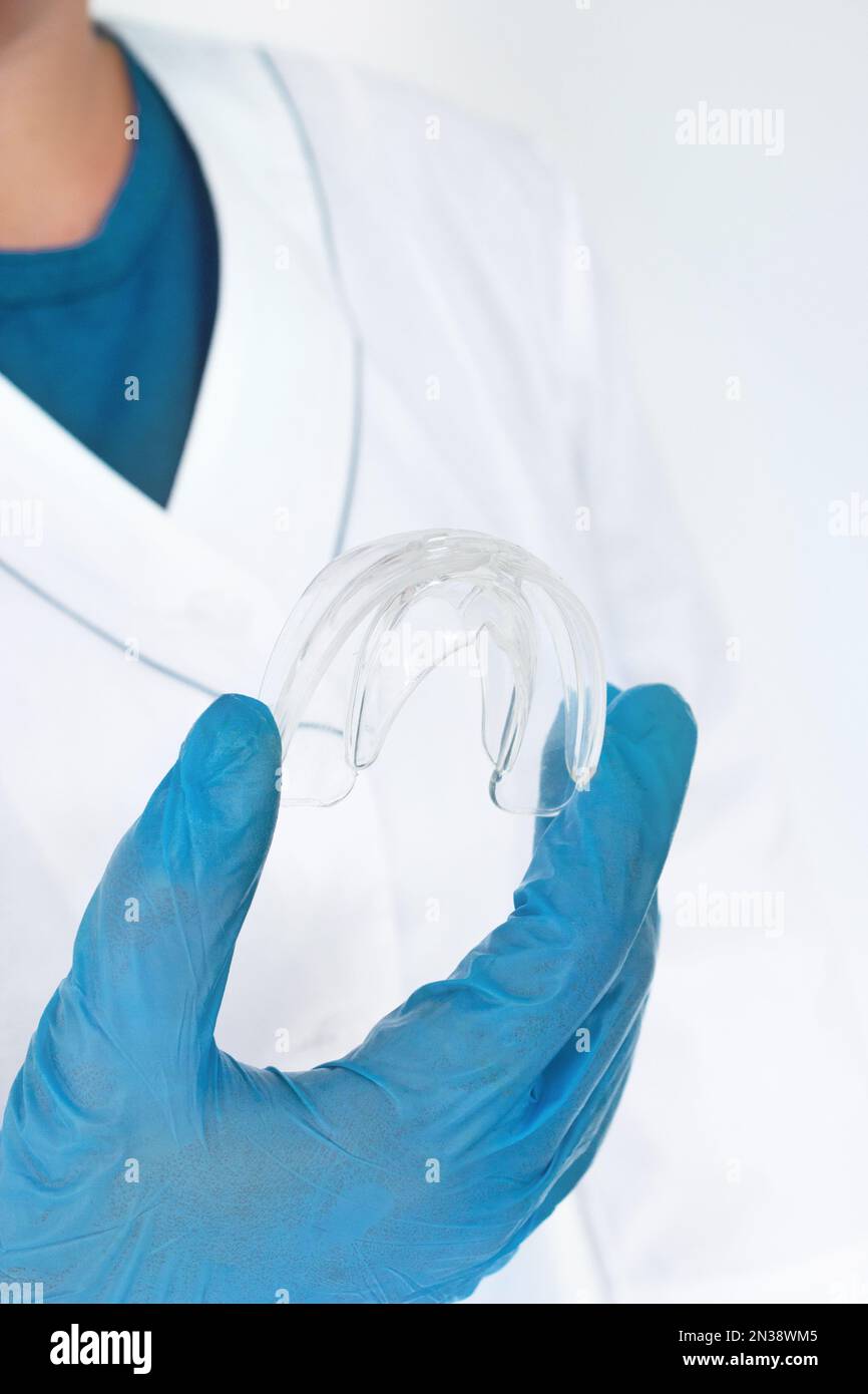 Teeth Whitening Tooth Tray in doctors hand, Closeup. Invisible