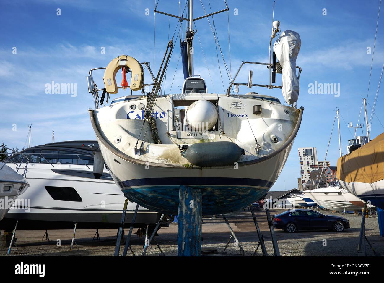 Cabin cruiser on dry land in a boat yard at Ipswich marina, Suffolk, UK