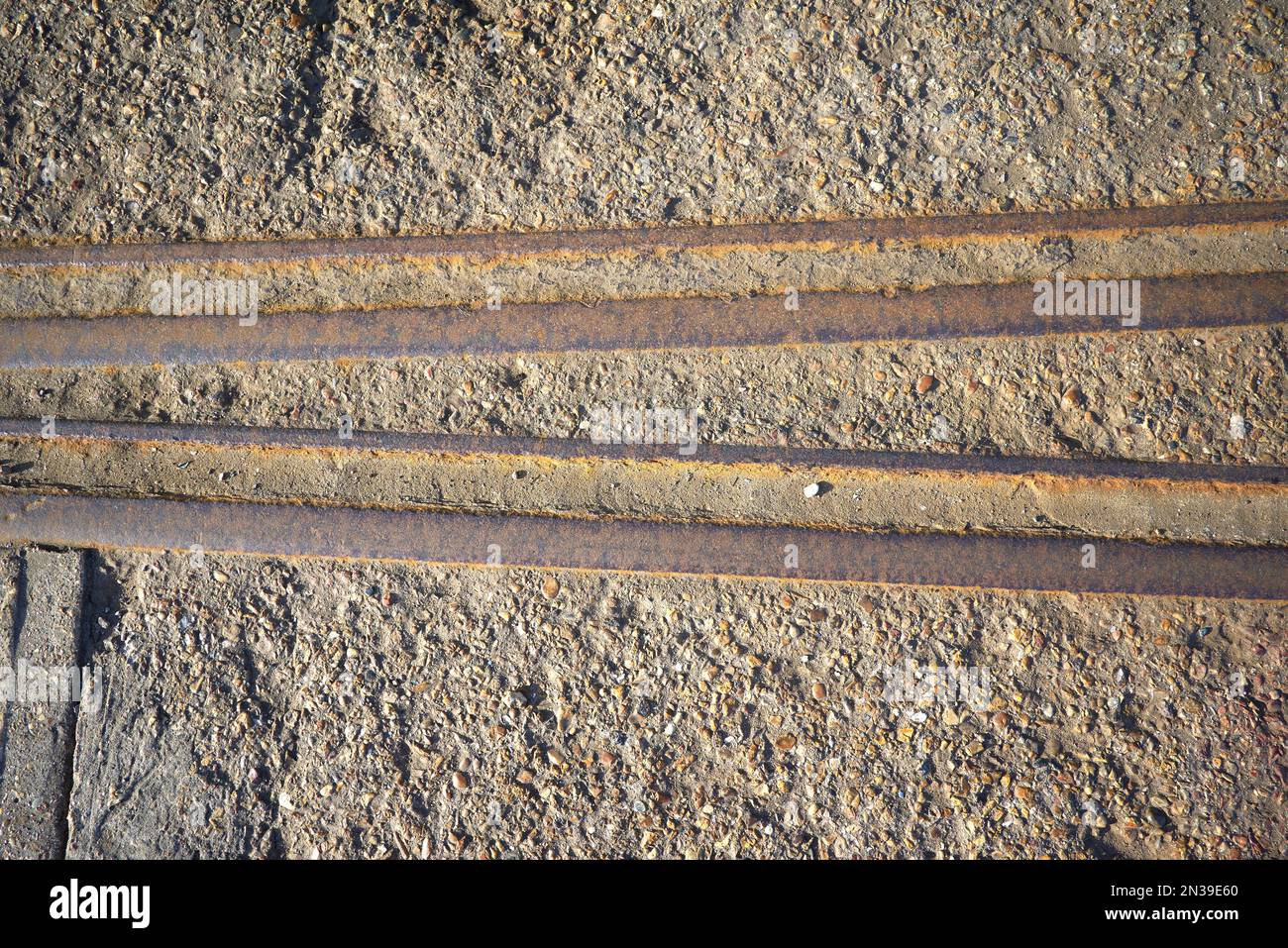 Old rusty railway track embedded in concrete Stock Photo Alamy