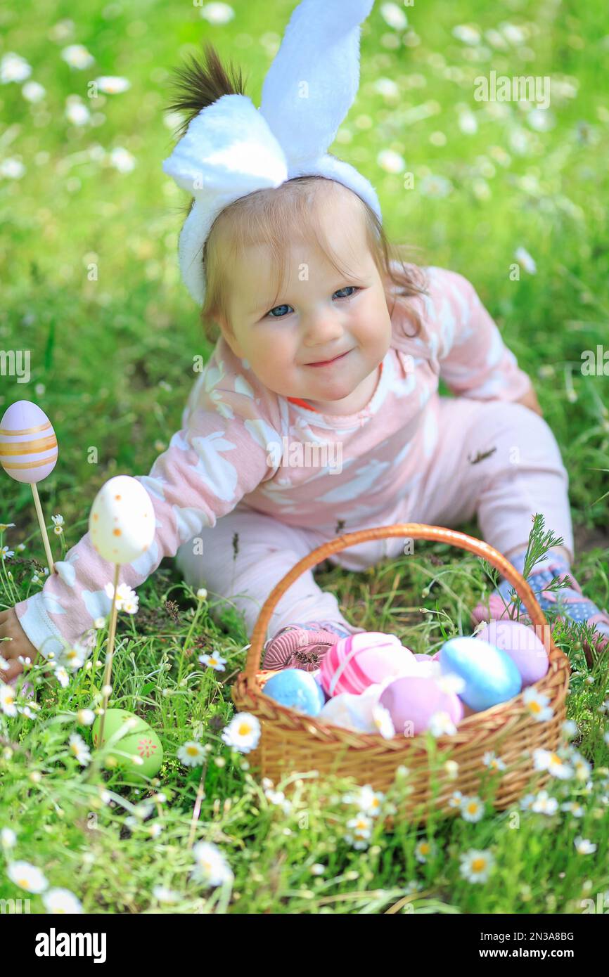 Child searching for eggs in garden. Little girl having fun on Easter