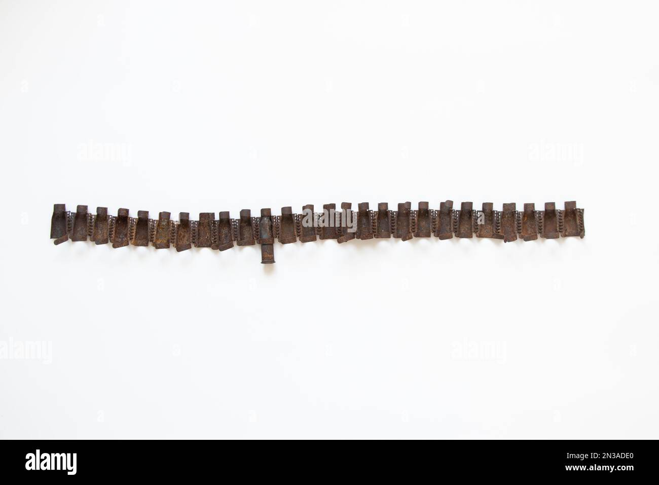 Machine-gun belt torn from a Russian tank on a white background, military weapon Stock Photo