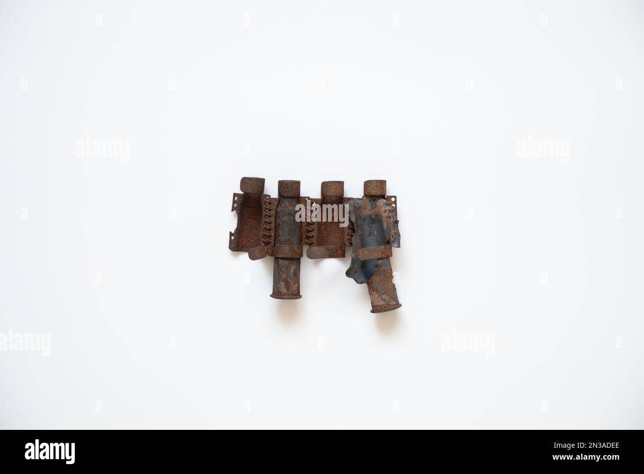 Machine-gun belt torn from a Russian tank on a white background, military weapon Stock Photo