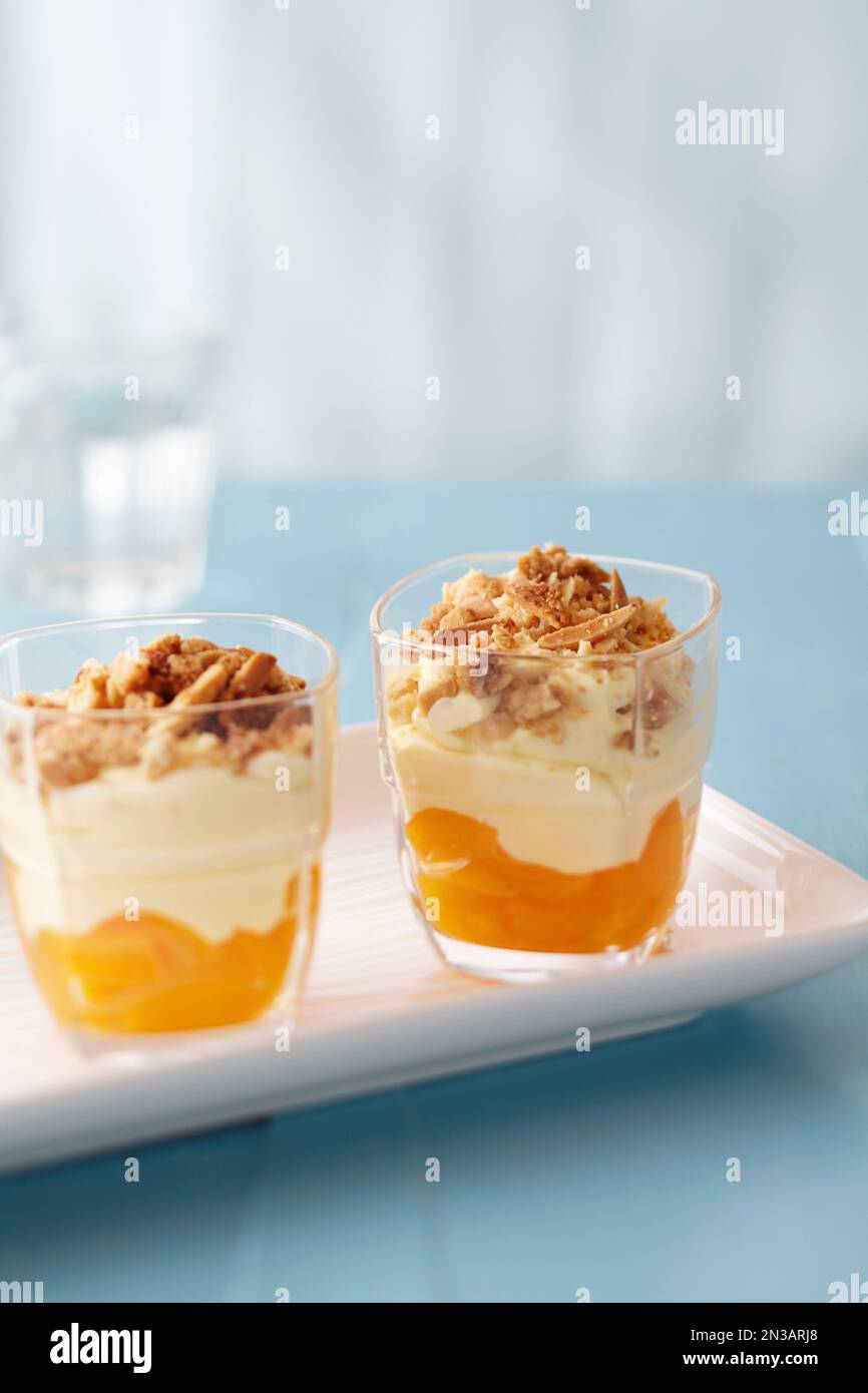 Fruit parfait with nut topping on a blue background Stock Photo