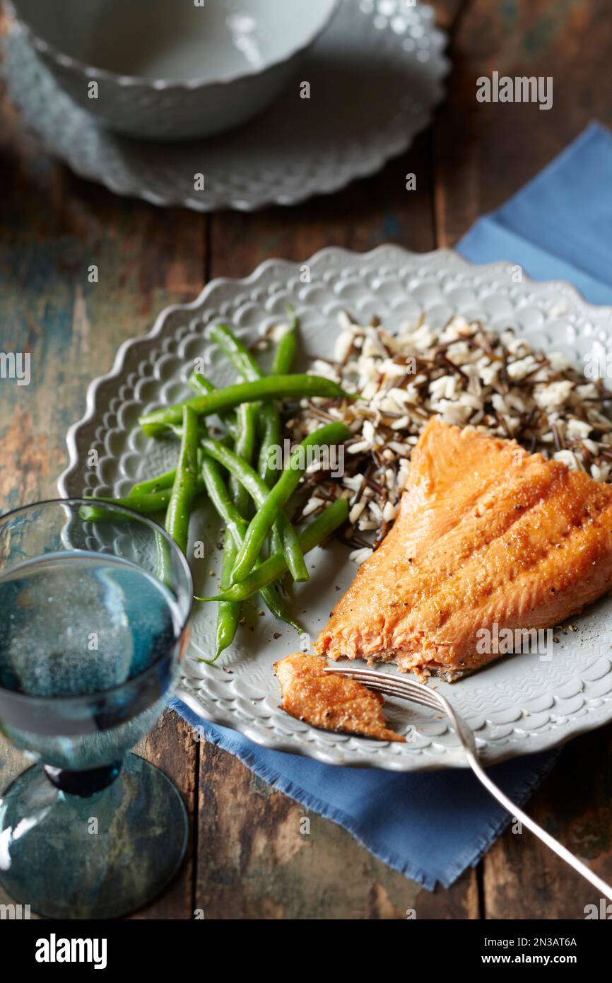 Arctic char fillet with wild rice and green beans Stock Photo Alamy