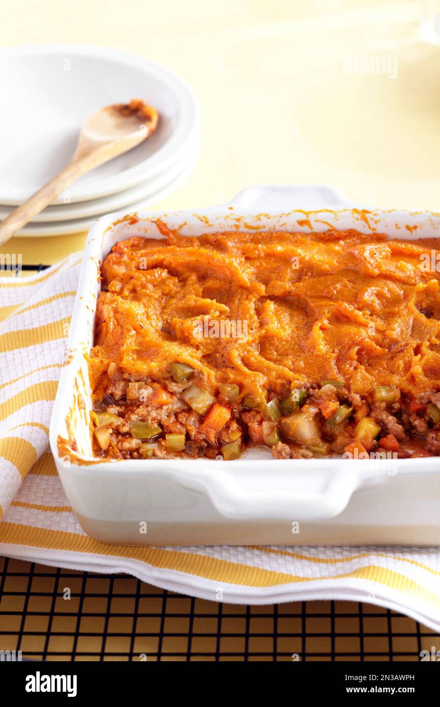 Sweet potato shepherds pie in a casserole dish with yellow striped tea ...