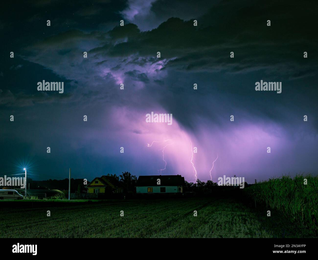 Lightning storm over a rural area lits up the sky at night Stock Photo ...