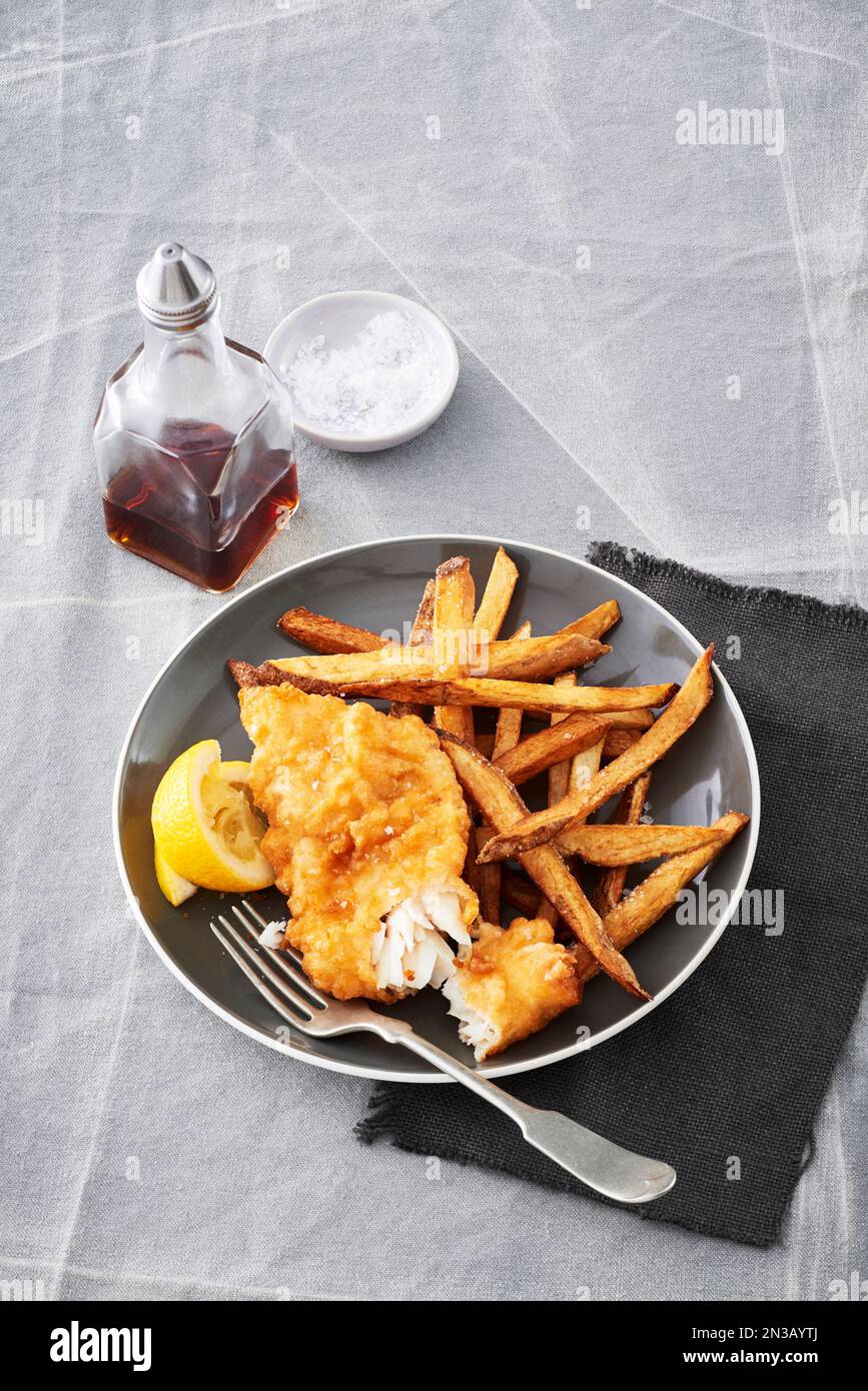 Fish and chips with malt vinegar on a grey backround Stock Photo