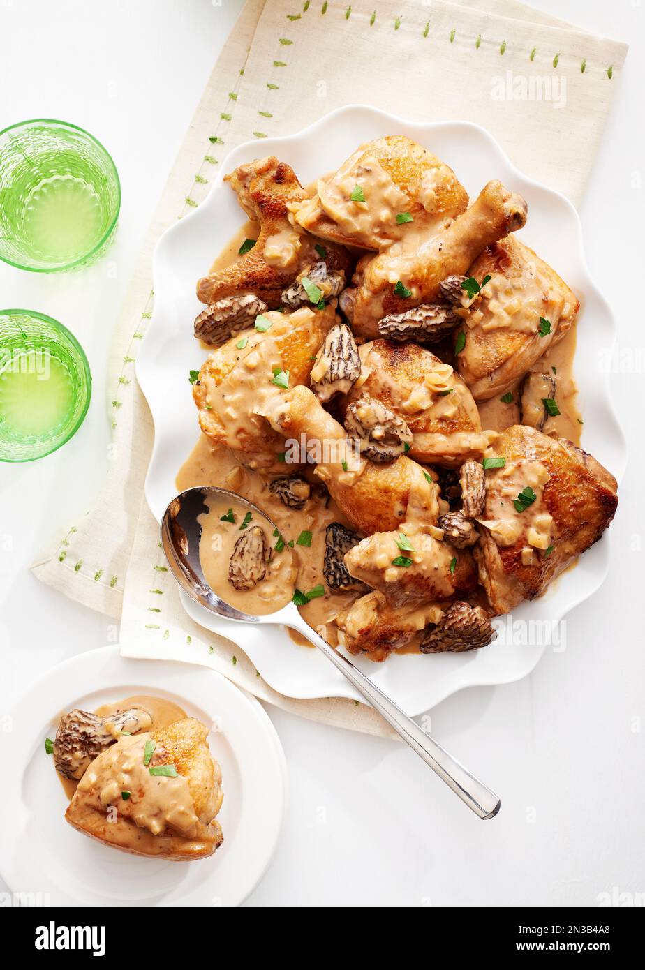 Chicken with morel mushroom sauce served on a fancy white platter with