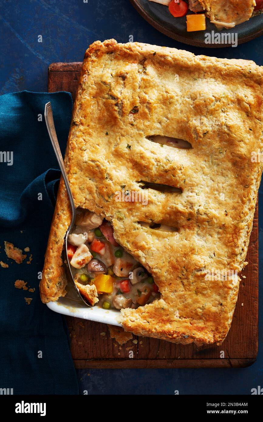 Family sized chicken pot pie with a portion taken out Stock Photo