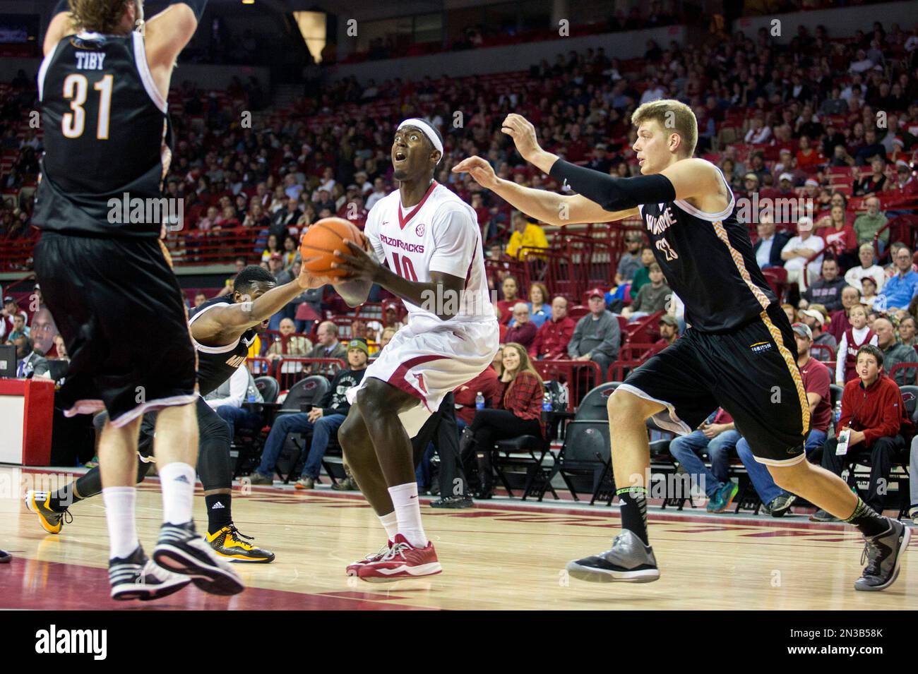 Arkansas forward Bobby Portis, center, looks to shoot over Milwaukee