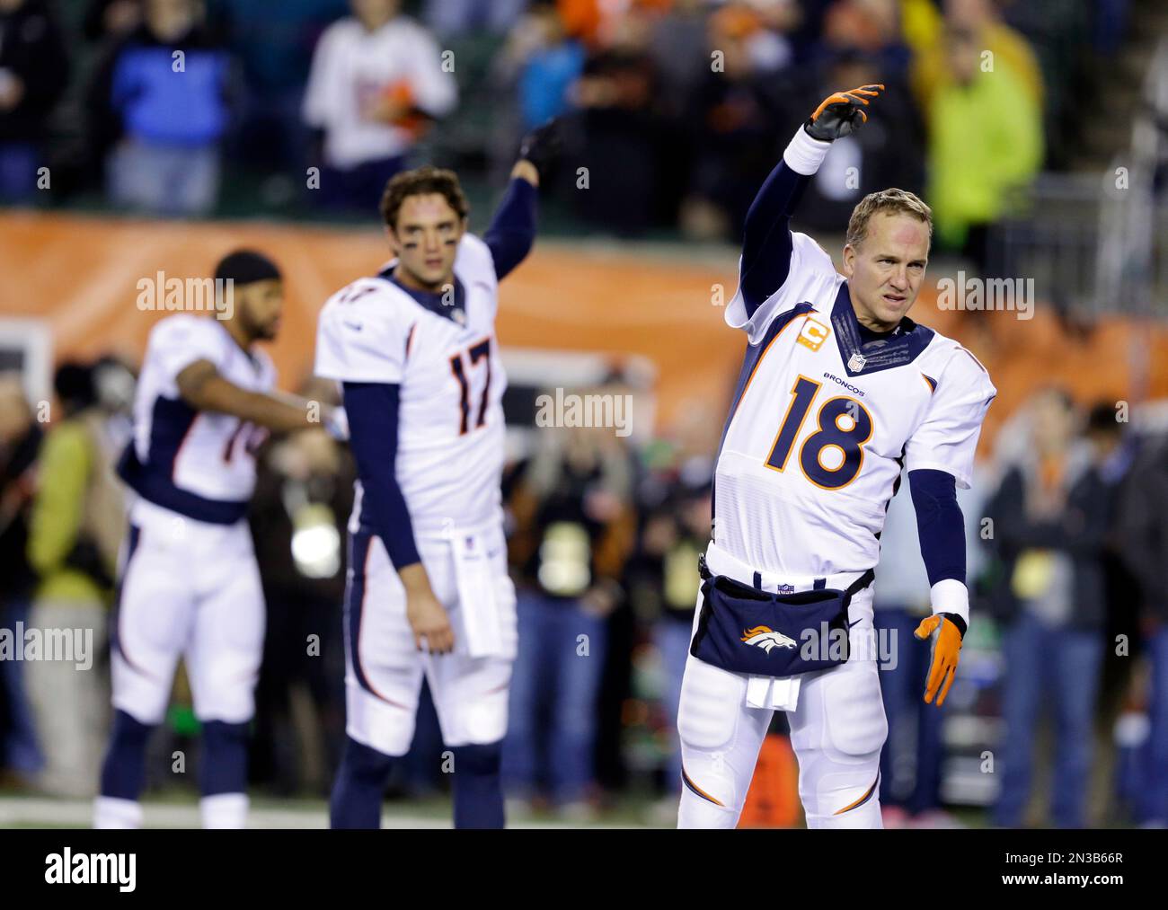 Denver Broncos quarterback Peyton Manning (18) warms up with Brock ...