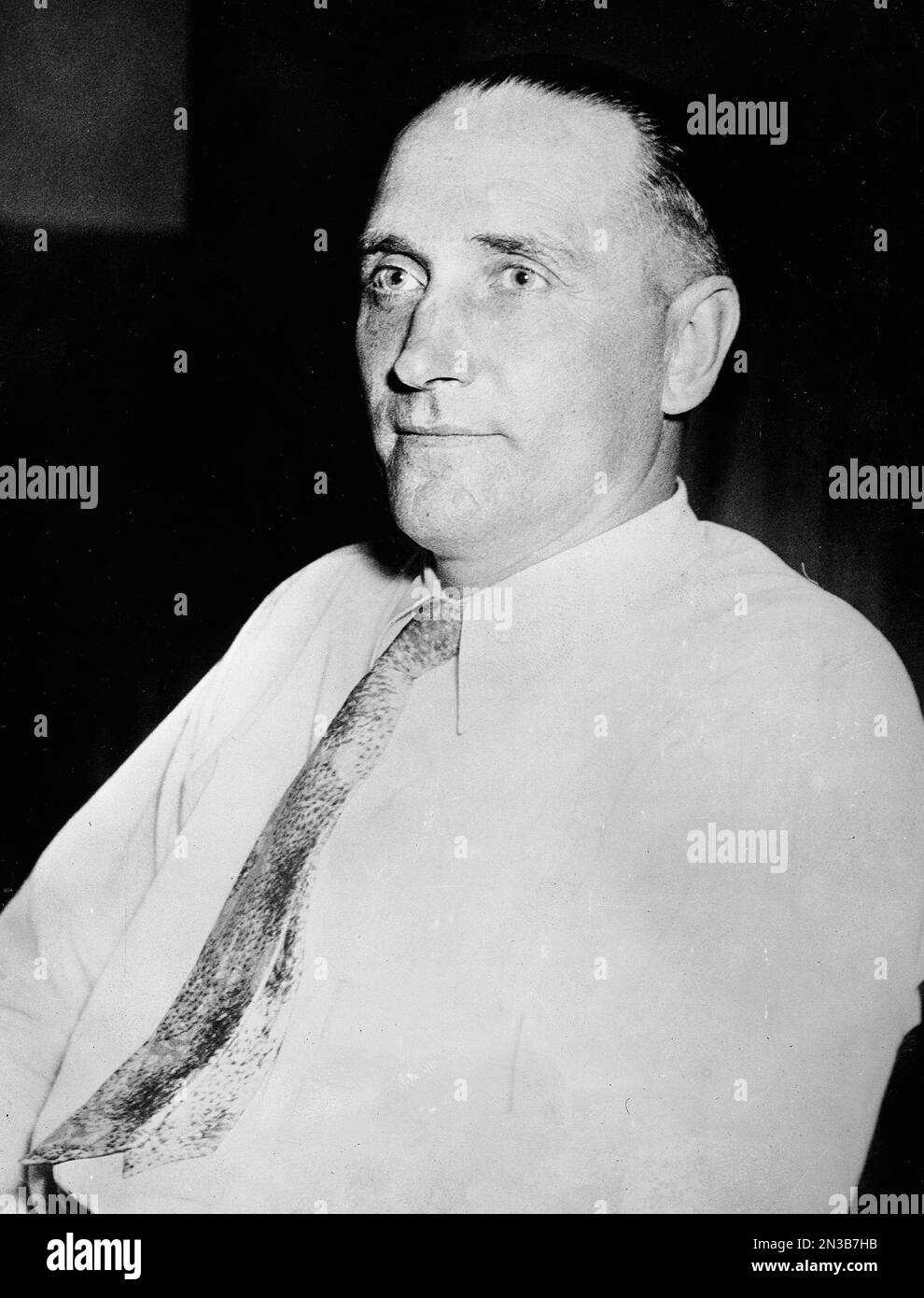Albert Bates, suspected kidnapper of Oklahoma City oil millionaire Charles F.  Urschel, is shown as he was brought to the police station in Denver, Colo.,  Aug. 16, 1933. The arrest of Bates
