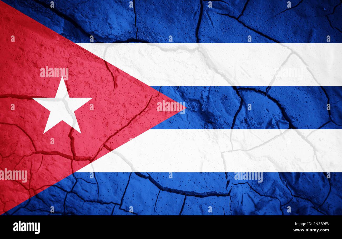 Flag of Cuba. Cuba symbol. Flag on the background of dry cracked earth. Cuba flag with drought concept Stock Photo