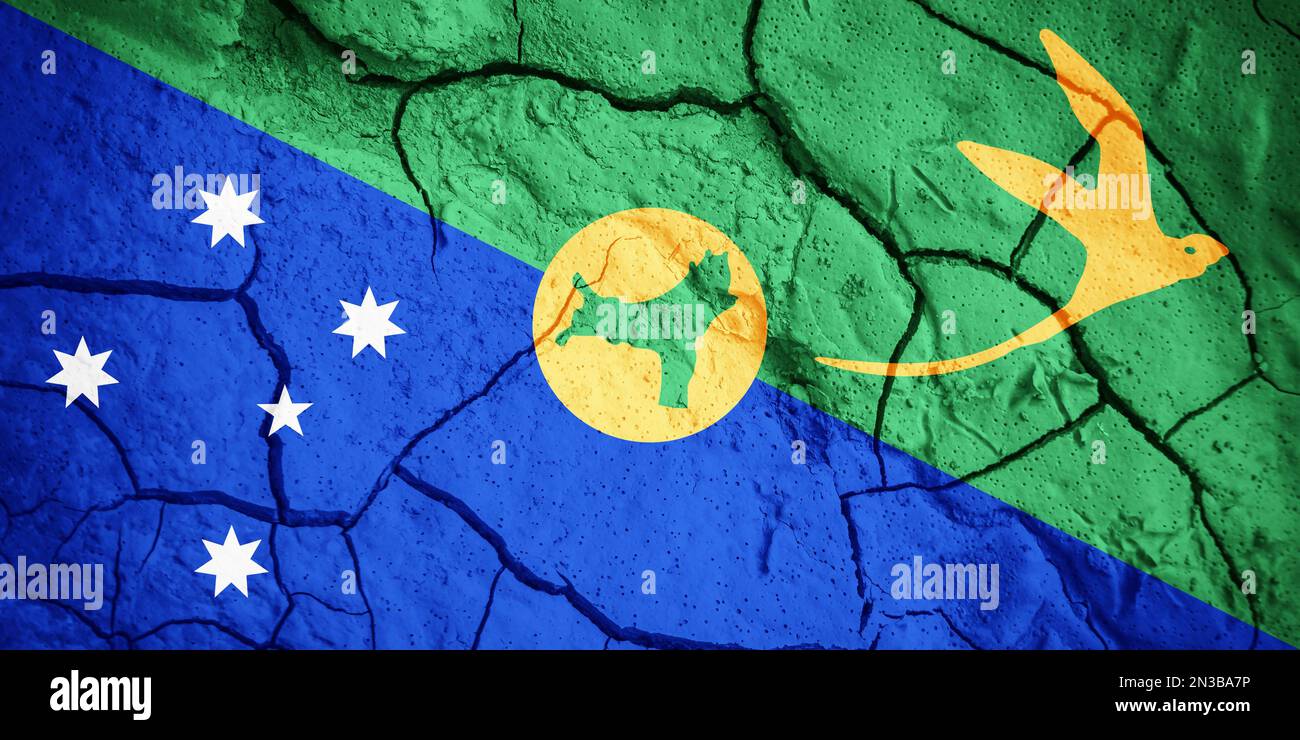 Flag of Christmas island. Christmas island symbol. Flag on the background of dry cracked earth. Christmas island flag with drought concept Stock Photo