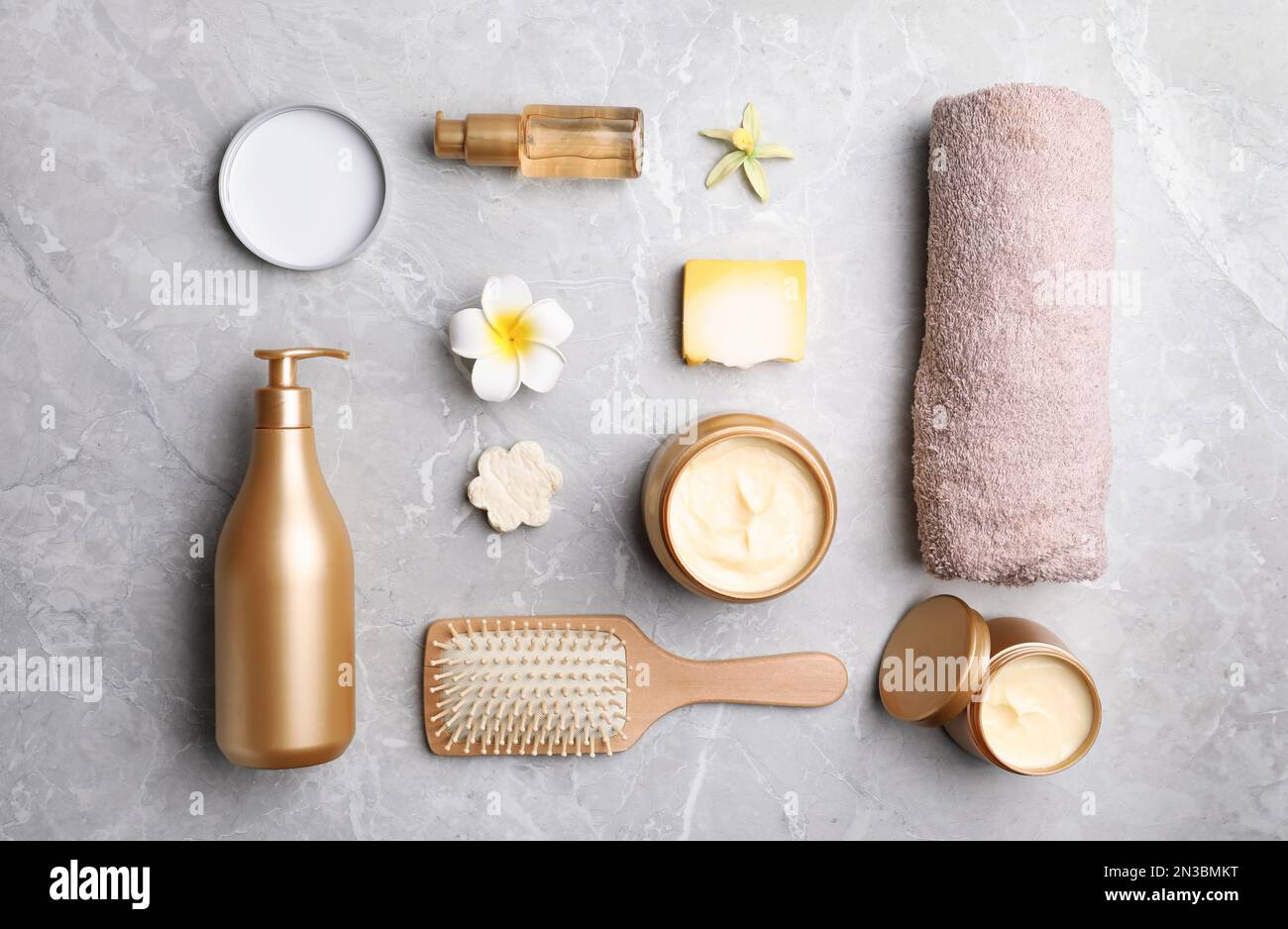 Flat lay composition with hair cosmetic products on grey marble table ...