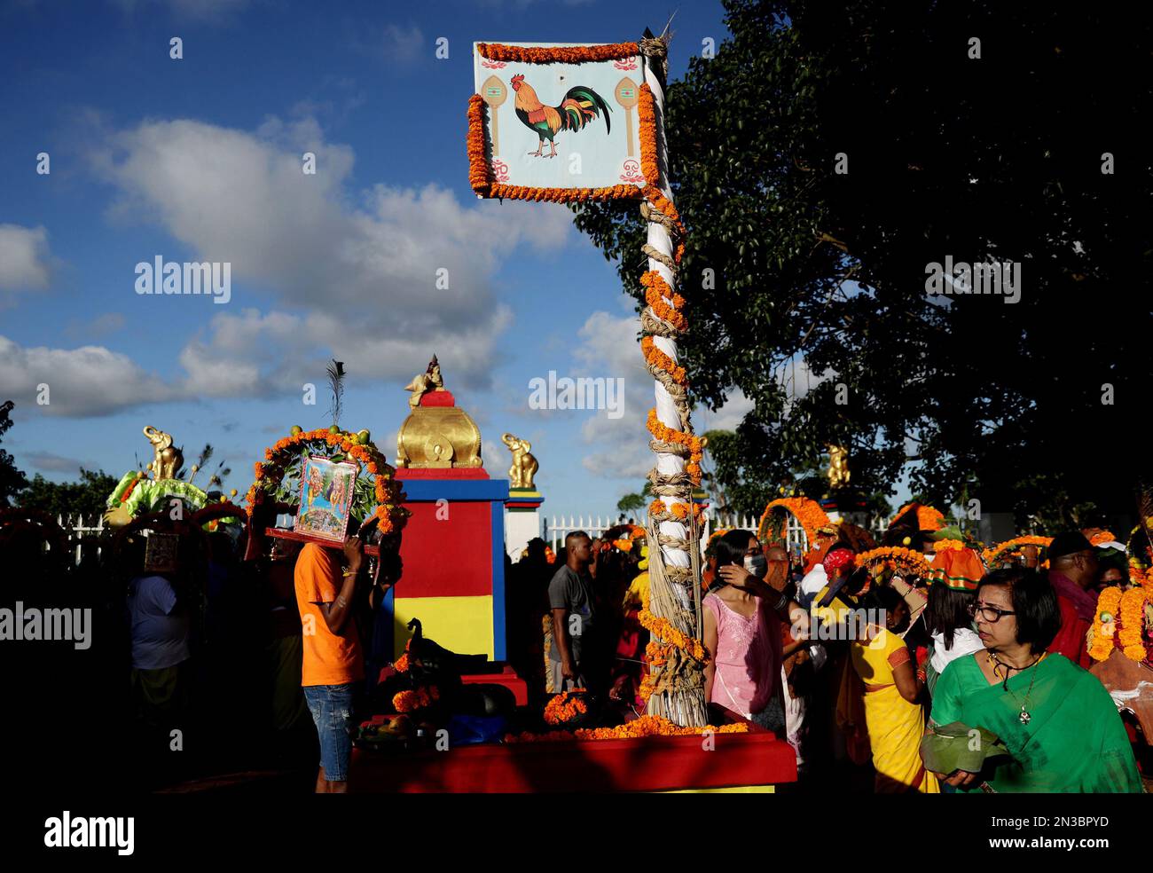 A flag bearing an image of a rooster flies up at Grammadave Alayam temple  during the annual Thaipoosam Kavady festival in Chatsworth, south of  Durban, South Africa on February 4, 2023. The