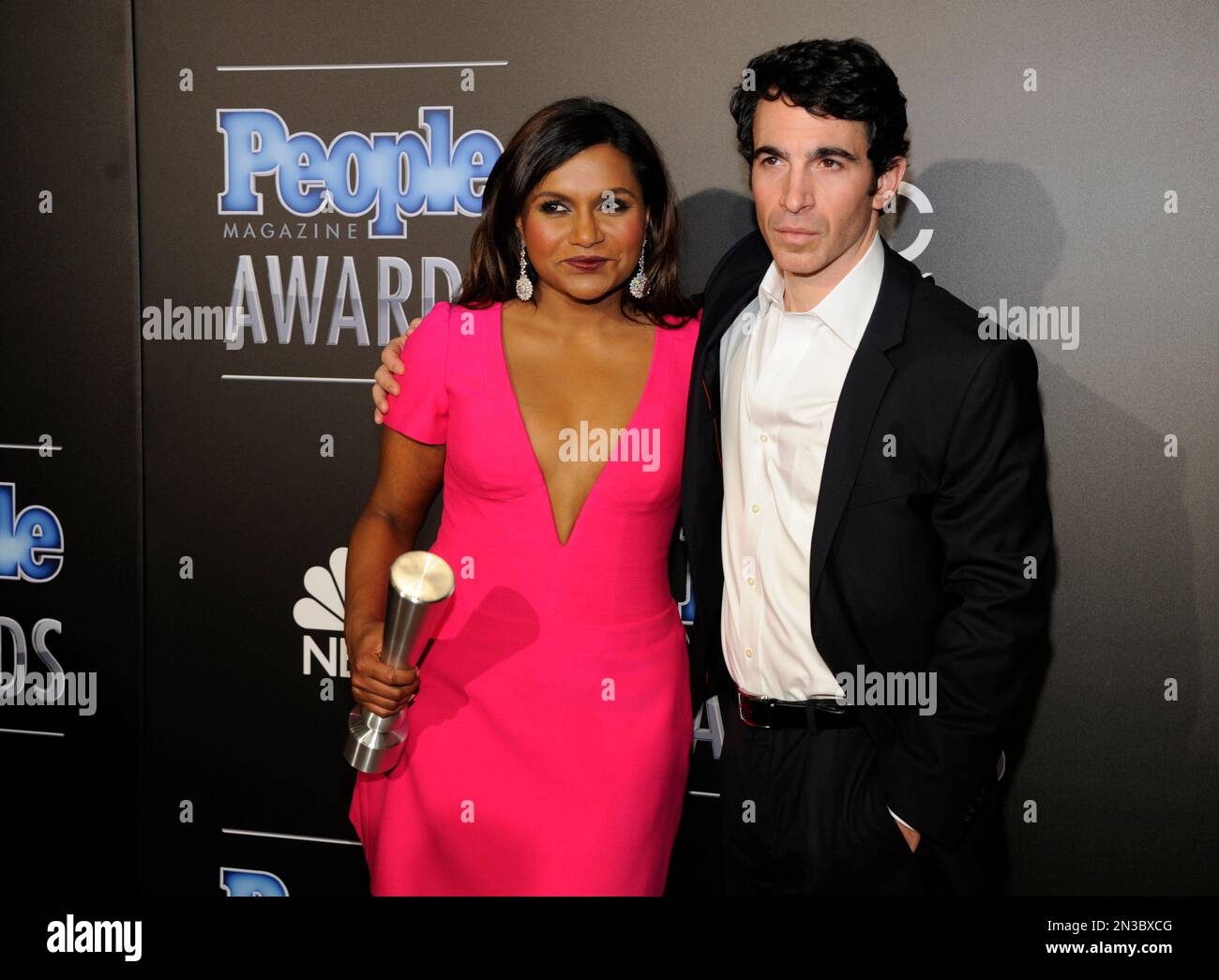 Mindy Kaling, left, and Chris Messina pose backstage with the award for