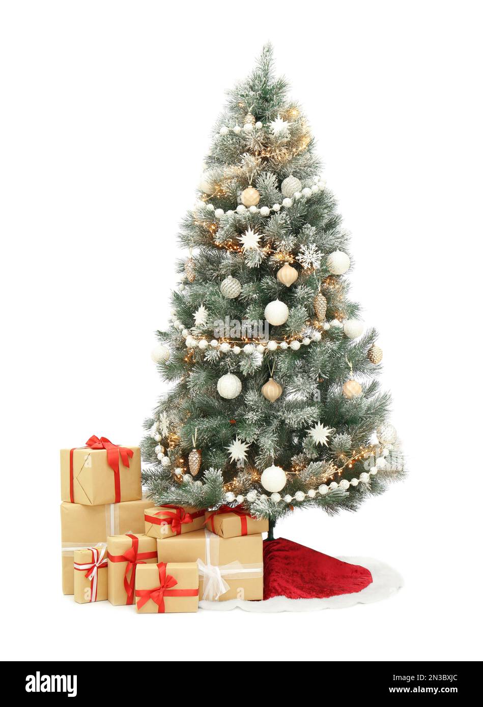 Decorated Christmas tree with red skirt and gift boxes on white ...