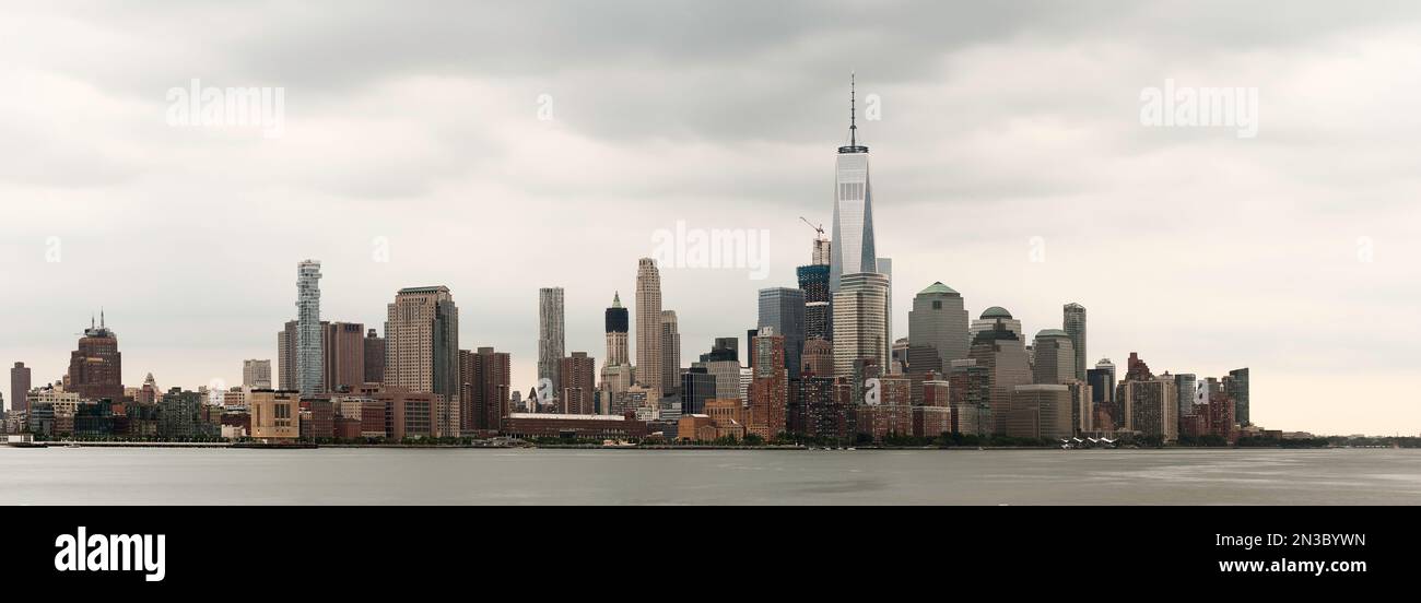 A wide photography of the downtown New York skyline in a cloudy day ...