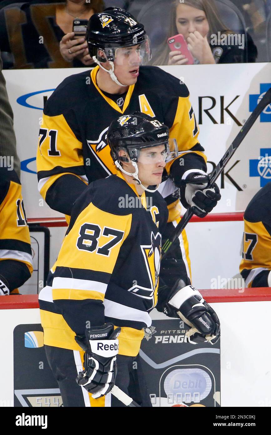 Pittsburgh Penguins' Sidney Crosby (87) and Evgeni Malkin (71) take the